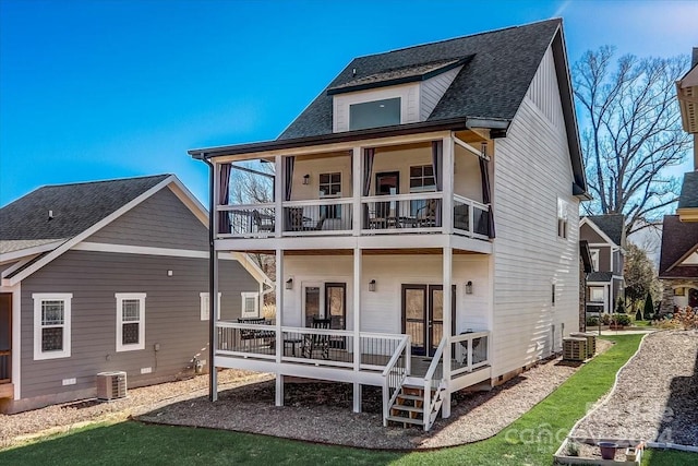 rear view of property with french doors, a balcony, and cooling unit