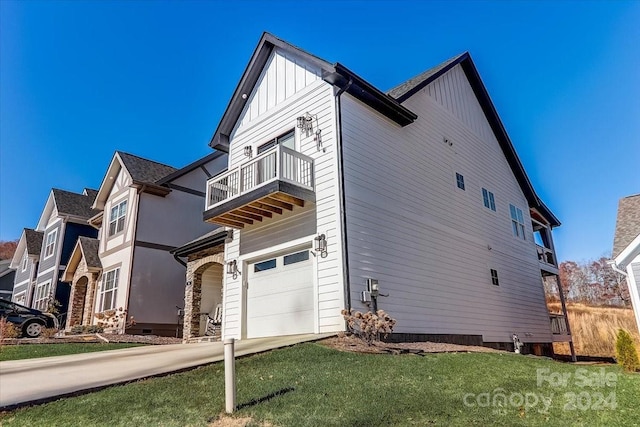 view of property exterior featuring a lawn, a balcony, and a garage