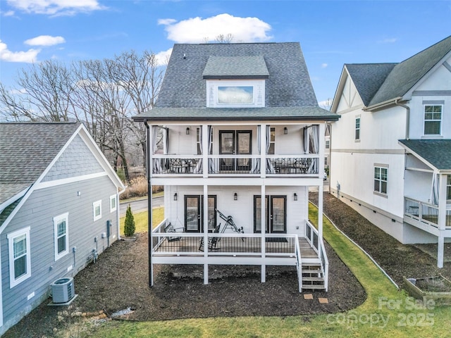 back of house featuring central AC unit, a balcony, and a porch