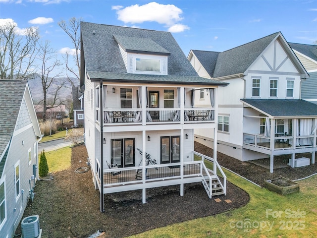 view of front of home featuring a balcony, central AC unit, and covered porch