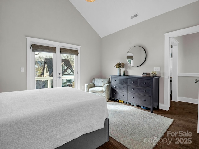 bedroom with high vaulted ceiling, access to outside, dark hardwood / wood-style flooring, and french doors