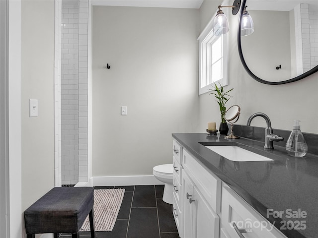 bathroom featuring vanity, tile patterned floors, and toilet