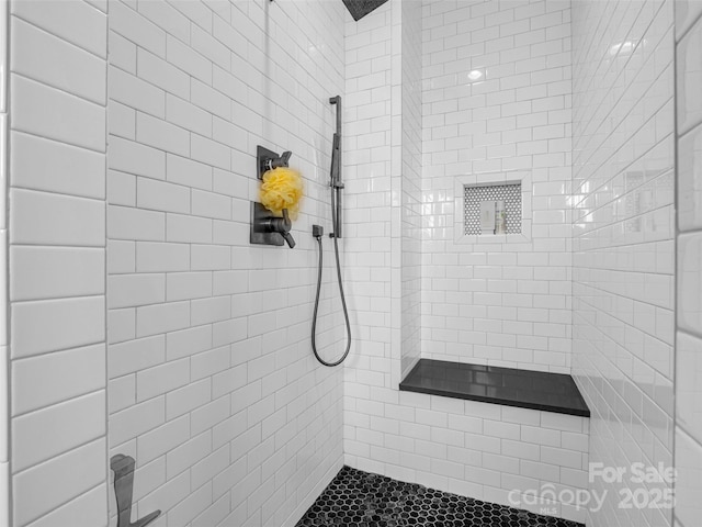 bathroom with a tile shower