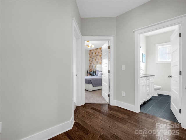 hall featuring dark wood-type flooring and sink