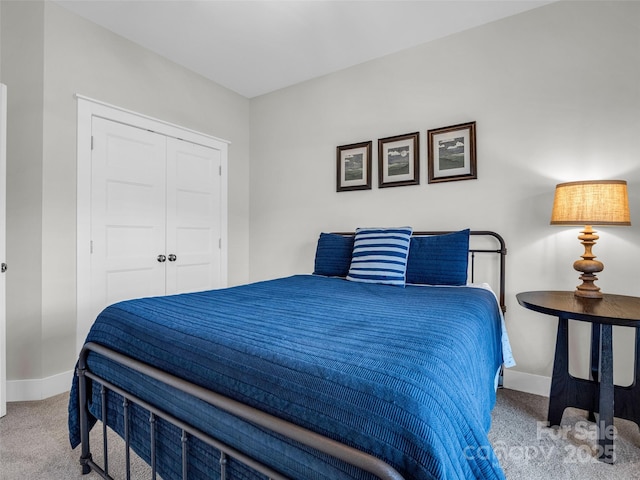 bedroom featuring light carpet and a closet