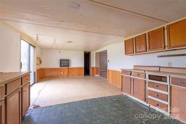 kitchen featuring wooden walls and heating unit