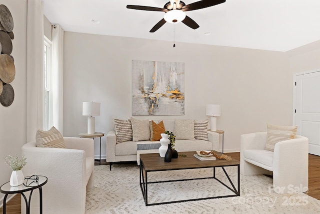 living room featuring ceiling fan and light hardwood / wood-style floors