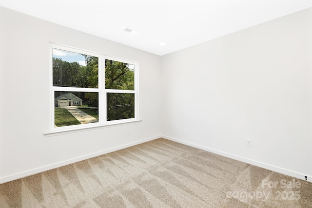 unfurnished room featuring carpet