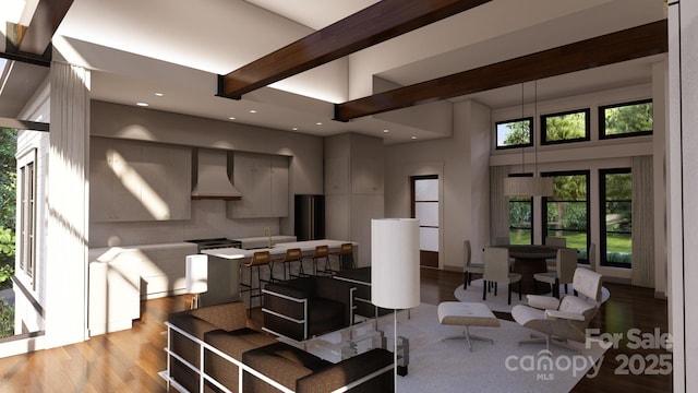 living room featuring a towering ceiling, light hardwood / wood-style flooring, and beamed ceiling