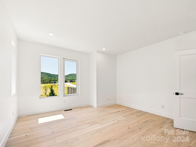 unfurnished room with light hardwood / wood-style flooring