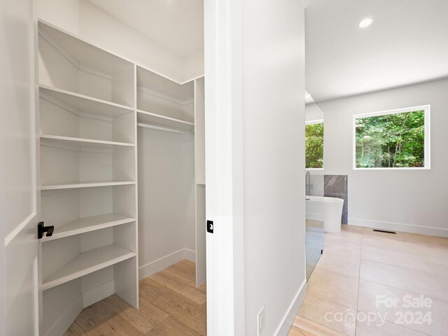 walk in closet featuring light hardwood / wood-style floors