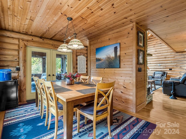 dining area with wooden ceiling, hardwood / wood-style floors, rustic walls, and french doors