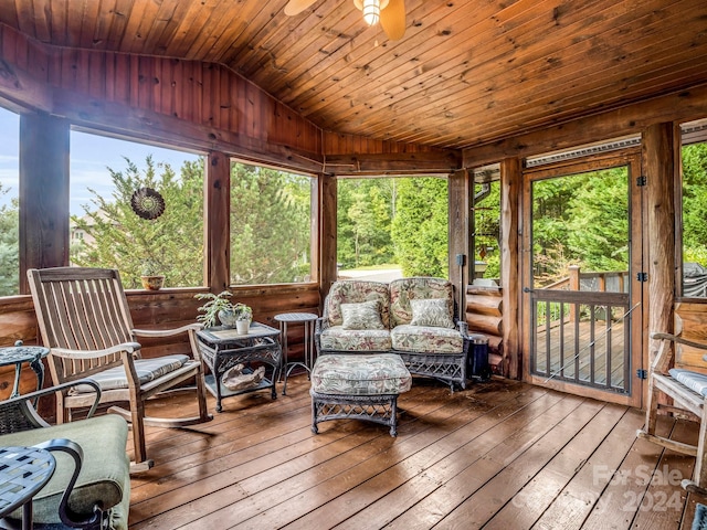 sunroom / solarium with ceiling fan, vaulted ceiling, and wooden ceiling