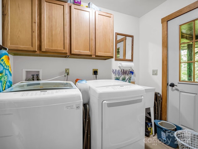 laundry area featuring cabinets and separate washer and dryer