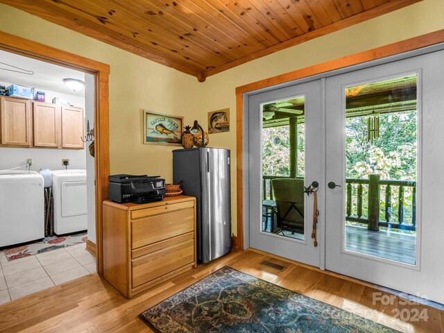 interior space with light hardwood / wood-style floors, wooden ceiling, french doors, and washer and clothes dryer