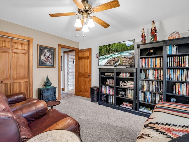 carpeted living room with ceiling fan