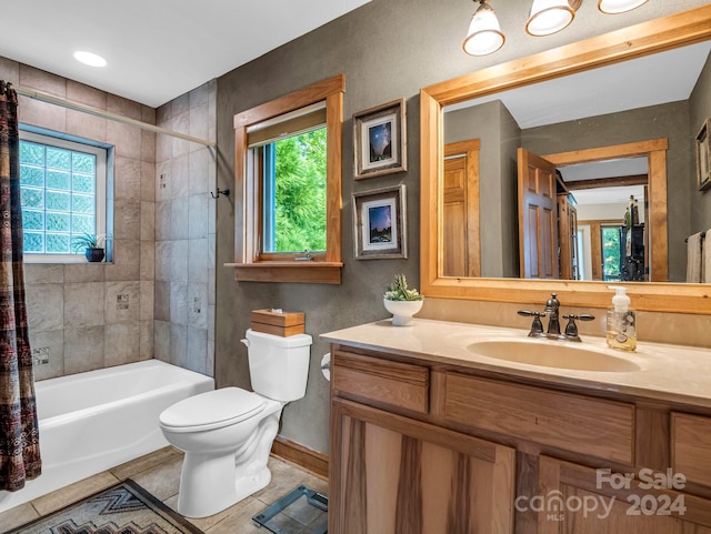 full bathroom with vanity, shower / tub combo, toilet, and a healthy amount of sunlight