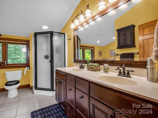 bathroom with vaulted ceiling, vanity, a shower with door, toilet, and tile patterned floors