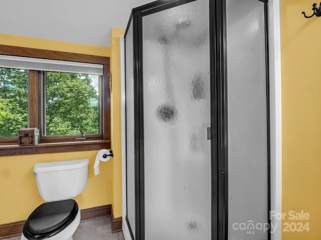 181 Highland Hts, Lake Lure, NC 28746 - bathroom featuring tile patterned flooring, a shower stall, toilet, and baseboards