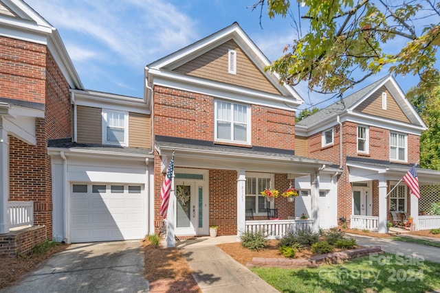 view of front of property featuring a porch and a garage