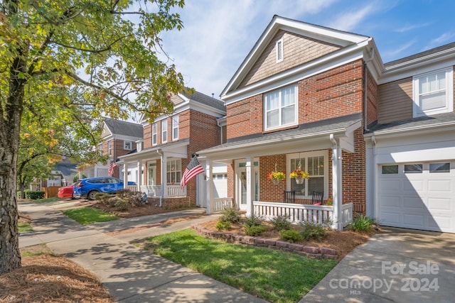 view of front facade featuring a porch and a garage