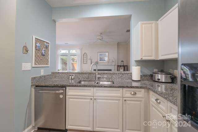 kitchen featuring ceiling fan, sink, stone counters, white cabinetry, and dishwasher