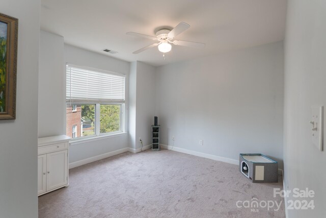 carpeted empty room with ceiling fan