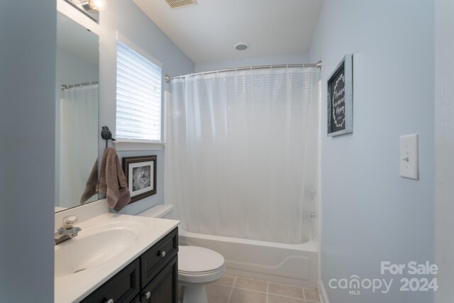 full bathroom with shower / bath combo, vanity, toilet, and tile patterned floors