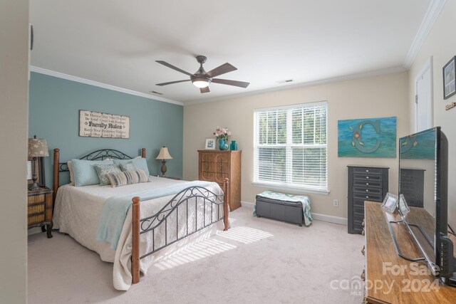 bedroom with crown molding, ceiling fan, and light colored carpet