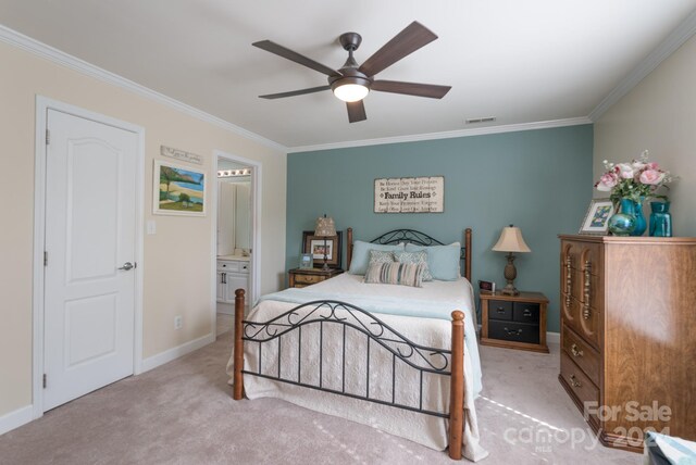 bedroom featuring ceiling fan, ornamental molding, light colored carpet, and ensuite bathroom