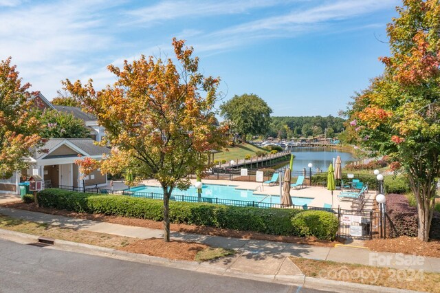 exterior space featuring a water view and a swimming pool