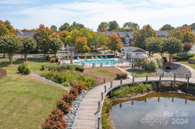 exterior space with a gazebo, a yard, a water view, and a patio area