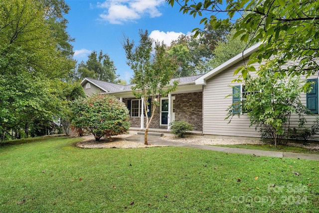 rear view of house with a lawn