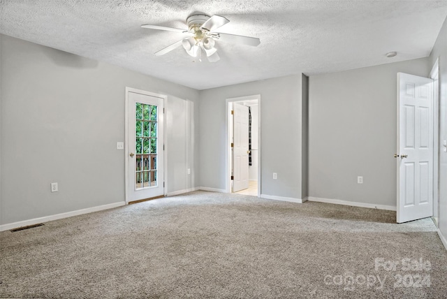 carpeted empty room with a textured ceiling and ceiling fan