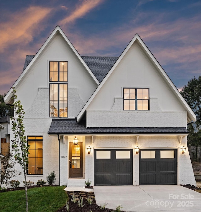 modern farmhouse featuring a yard and a garage