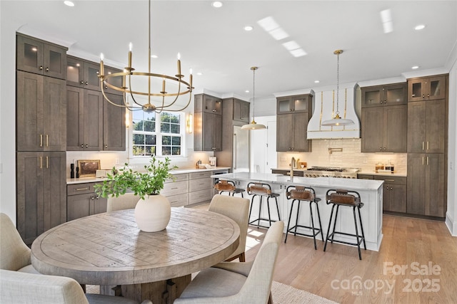 dining area featuring light hardwood / wood-style flooring and a chandelier