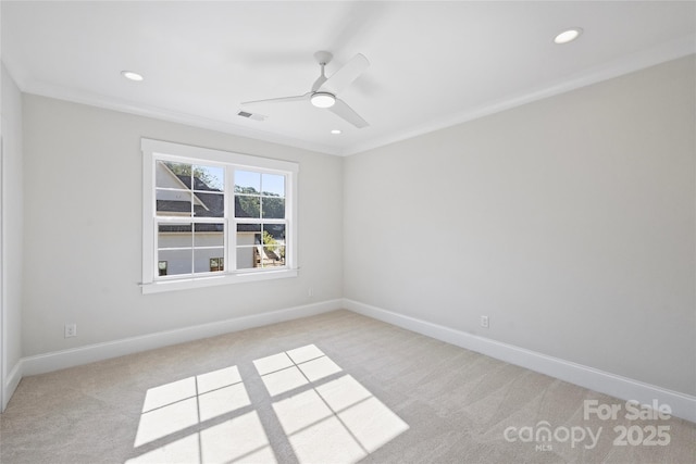 carpeted empty room featuring ceiling fan and ornamental molding