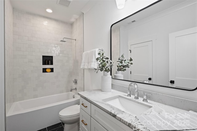 full bathroom featuring toilet, vanity, and tiled shower / bath