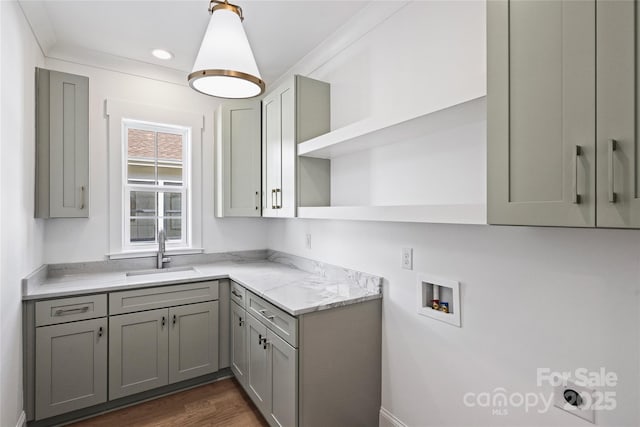 kitchen featuring gray cabinets, sink, light stone countertops, and dark wood-type flooring