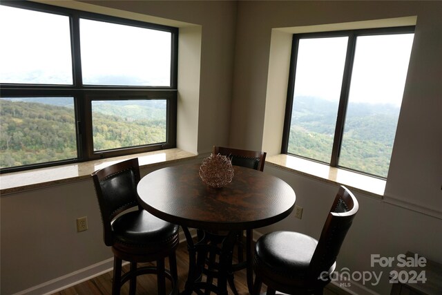 dining space with a mountain view and hardwood / wood-style flooring