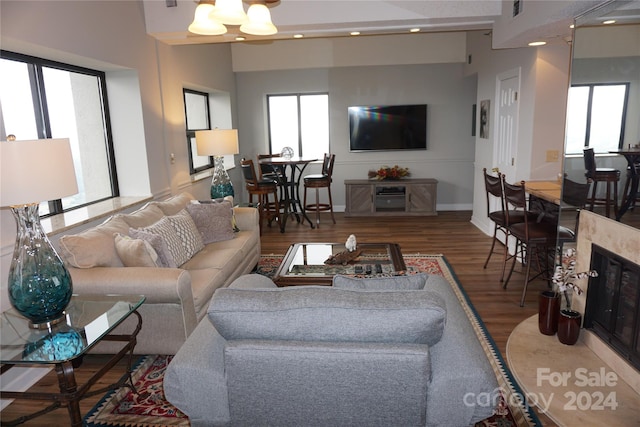 living room featuring hardwood / wood-style flooring and a high end fireplace