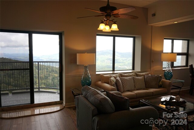 living room with ceiling fan and hardwood / wood-style flooring