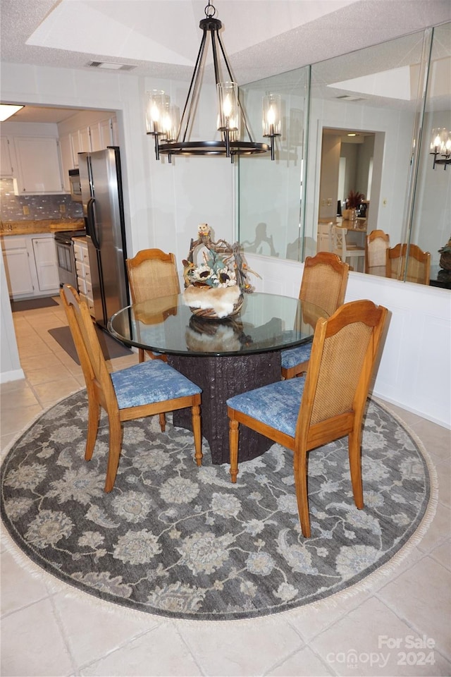 tiled dining area featuring a notable chandelier