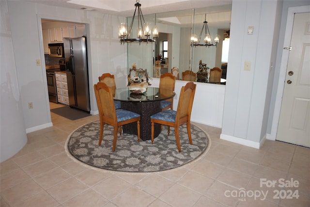 dining area featuring light tile patterned floors and a chandelier