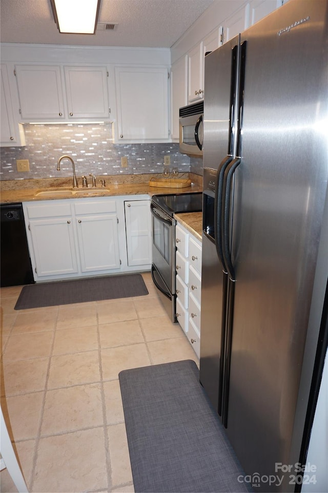 kitchen with sink, backsplash, white cabinetry, and black appliances