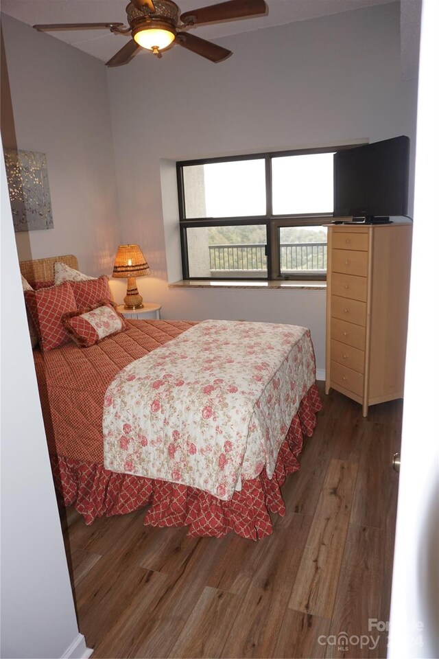 bedroom featuring ceiling fan and dark hardwood / wood-style floors