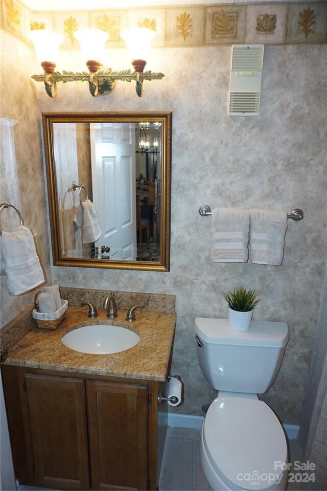 bathroom featuring vanity, toilet, and tile patterned floors