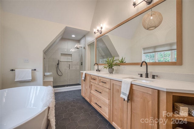 bathroom with tile patterned flooring, vanity, vaulted ceiling, and plus walk in shower