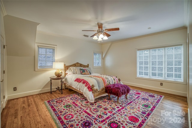 bedroom featuring ornamental molding, ceiling fan, and hardwood / wood-style flooring