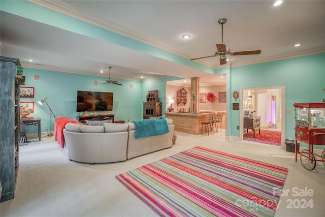 carpeted living room featuring crown molding, a fireplace, and ceiling fan